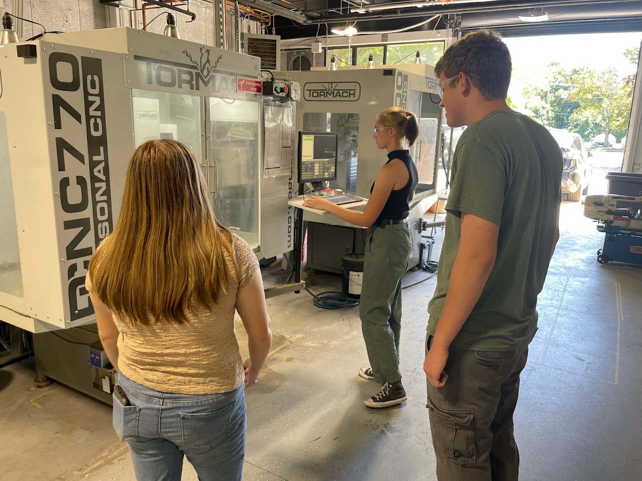 Image of Grace, Jackie, and I learning how to use the automatic milling machine